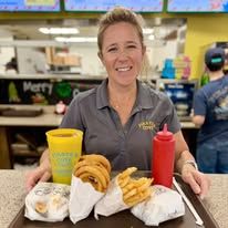 Mary Keith Rusbridge serving a tray at Pirate's Cove