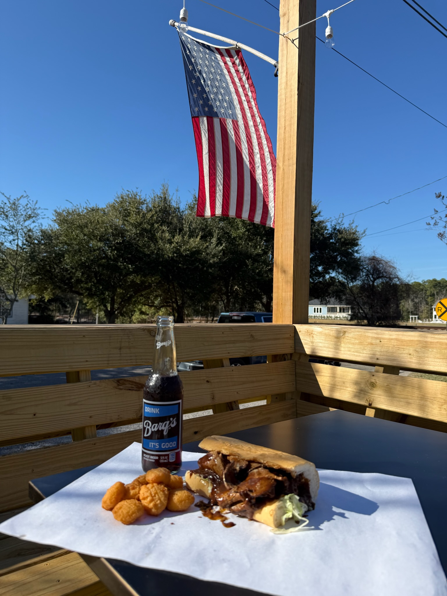 Pirate's Cove roast beef po-boy with gravy, corn nuggets, and a Barq's on the deck