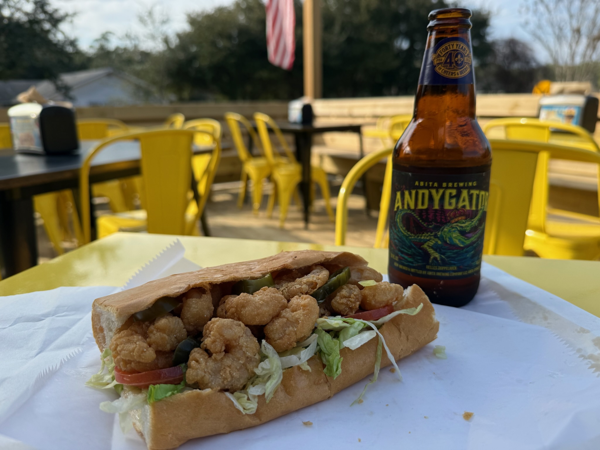 Fried Gulf shrimp po-boy on the deck with a cold beer